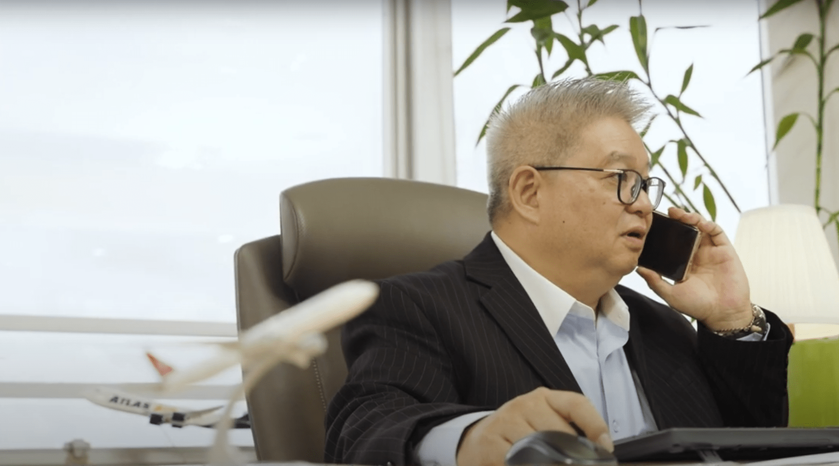 Mr. Chau Tin Lin talking over the phone.